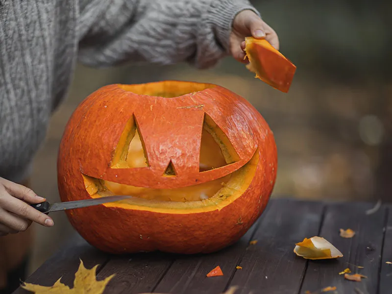Carving a face into a pumpkin