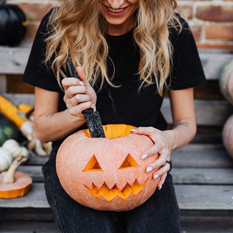 A carved pumpkin with a lit face